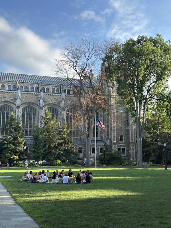 The University of Michigan campus with students walking along tree-lined paths